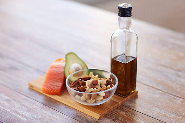 Healthy fats from olive oil, nuts and oily fish on a UK kitchen counter